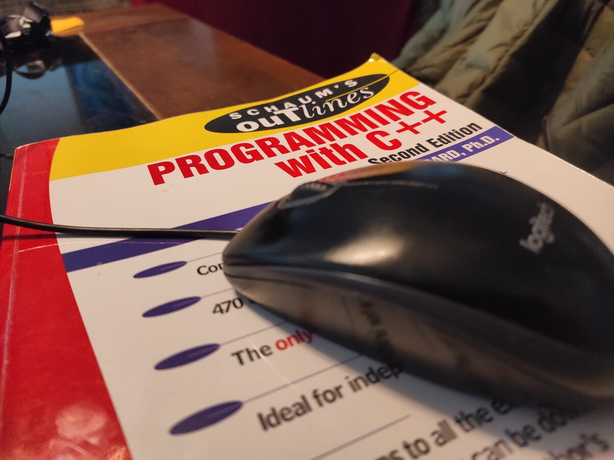 programming c++ book and computer mouse